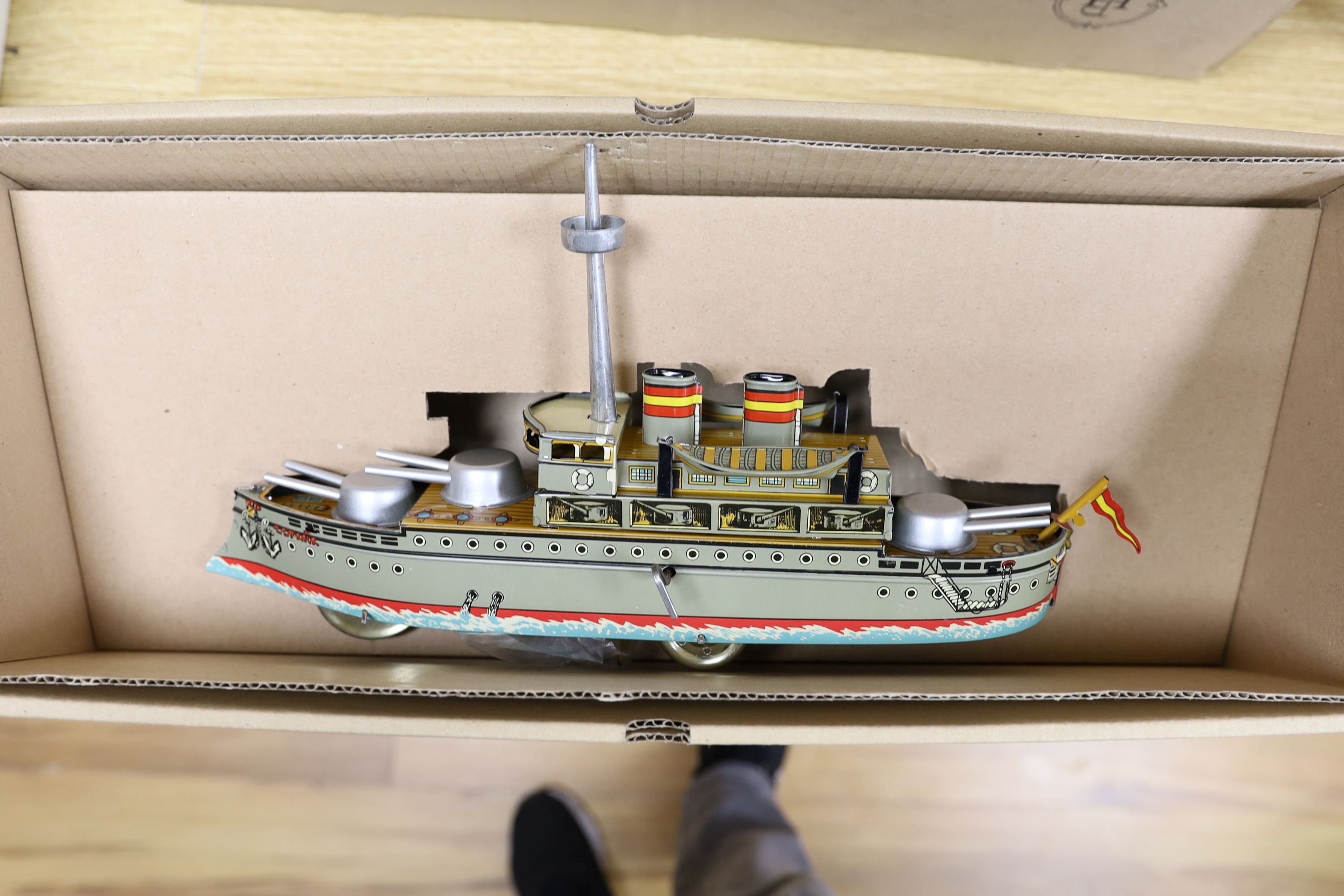 Three IBA tinplate boxed toys, two boats and a train, largest boat 42 cms wide.